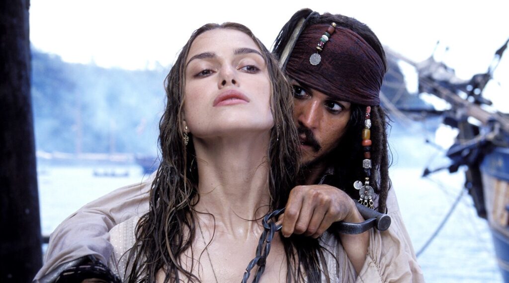 Elizabeth Swan (Keira Knightley) being held a knife point by Jack Sparrow (Johnny Depp) in 'Pirates of the Caribbean: The Curse of the Black Pearl' 