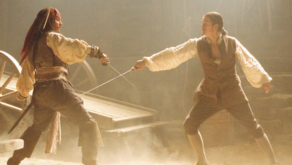 Jack Sparrow (Johnny Depp) and Will Turner (Orlando Bloom) sword fighting in 'Pirates of the Caribbean: The Curse of the Black Pearl'