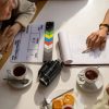 People gathered around a Table; 8 Ways to Get Visibility for Your Script